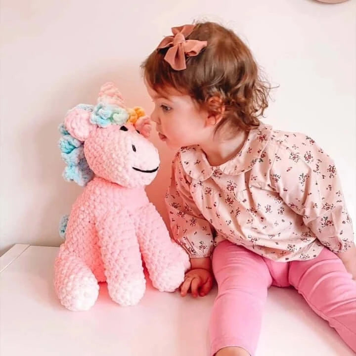 Toddler smiling with pink unicorn unique gift for a toddler baby gift