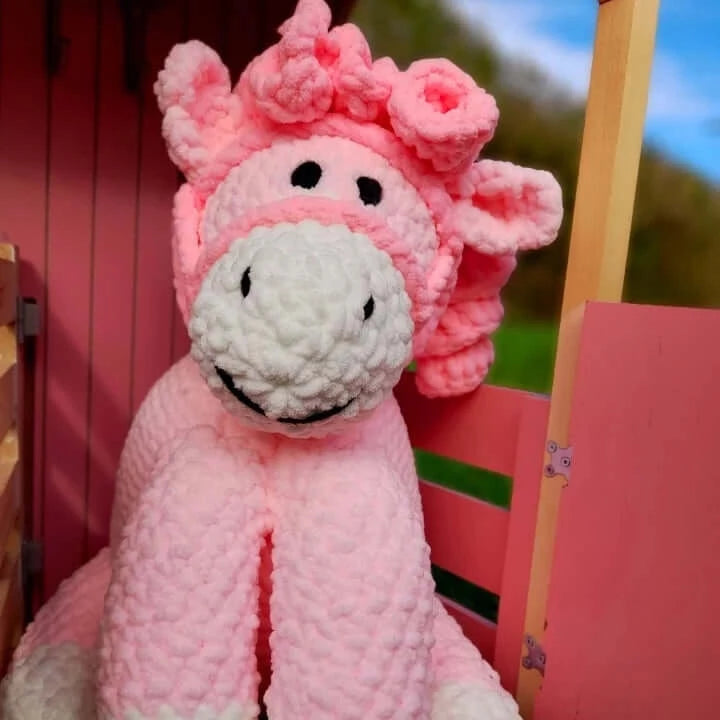 Pink pony stuffed toy with white nose and dark pink curly hair, unique baby gift for a toddler