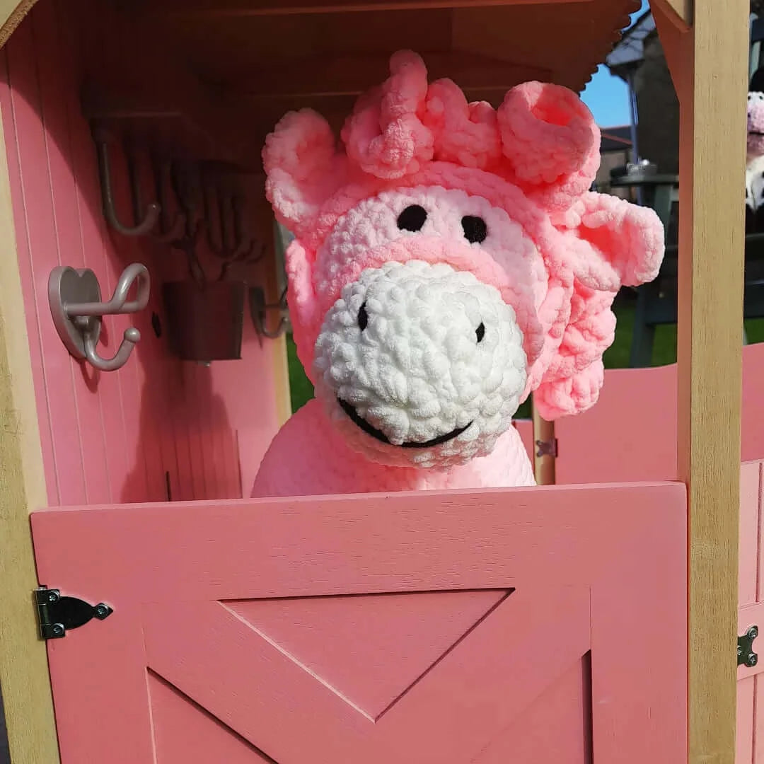 Pink pony stuffed toy with white nose and dark pink curly hair, unique baby gift for a toddler