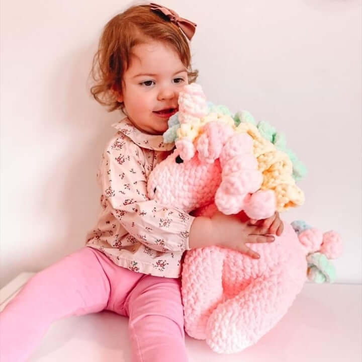 Toddler smiling with pink unicorn unique gift for a toddler baby gift