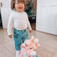 Toddler smiling with pink dinosaur plushy soft toy unique baby gift